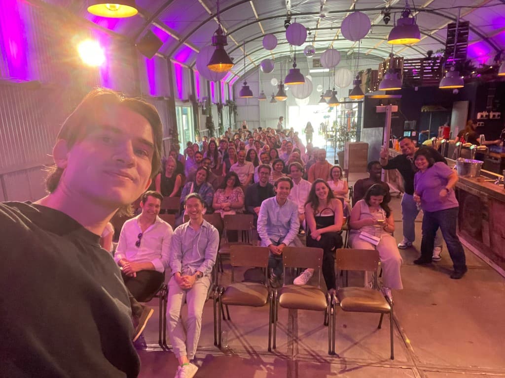 Group selfie at a community meetup in a warehouse venue