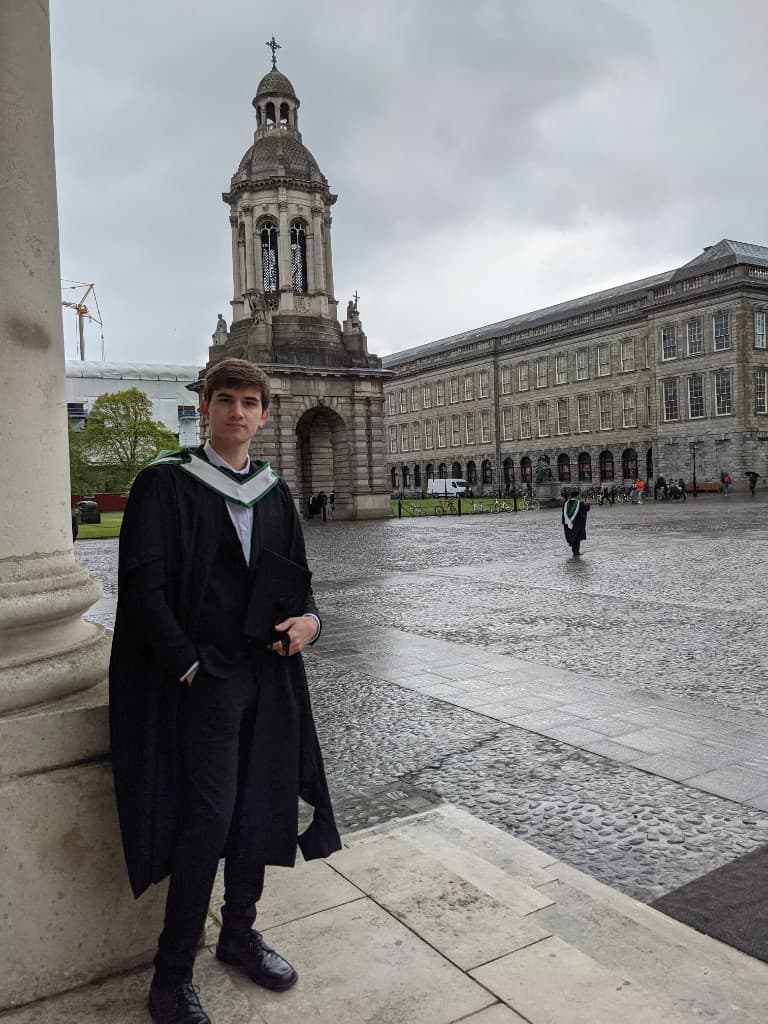 Graduation portrait in Trinity College courtyard with the Campanile behind